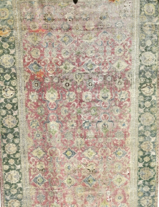 Indo-Isfahan Carpet, second half of the 17th century. Worn and with several generations of scattered repairs but complete. Apx. 8'x18'             