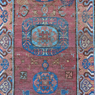 Khotan rug, smaller size measuring 3'6"x5'7". Classic central medallion design with a fantastic border. Areas of conservative restoration.               