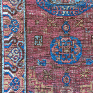 Khotan rug, smaller size measuring 3'6"x5'7". Classic central medallion design with a fantastic border. Areas of conservative restoration.               