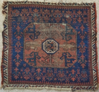 Baluch star bag with polychromatic blue, a blue-green and cinnamon ground. Looks older than most but worn.1 knot of cotton in lower right-center of field.        
