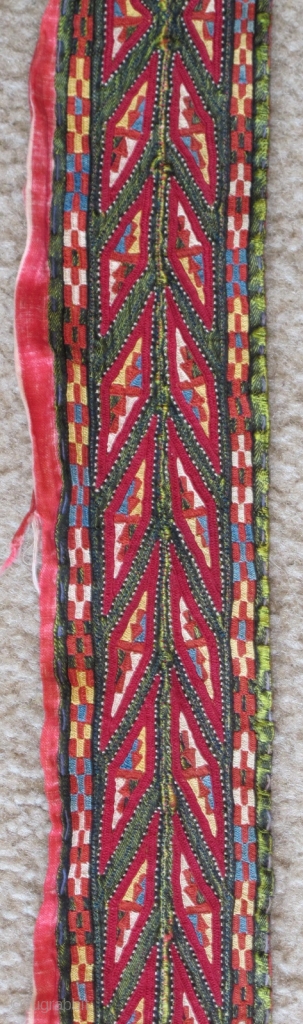 Tekke Turkmen embroidered band. Very fine. Very colorful with several blues, yellow, orange and insect red. Embroidered on a hand-woven green silk. 105x6cm          