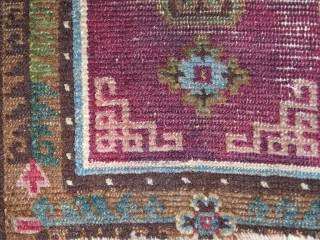 Tibetan saddle top with an insect red or madder ground. Nice ashik-looking quatrefoil medallion and vegetal border. All natural colors. Sometime in the 19th century? (54 x 68 cm)    