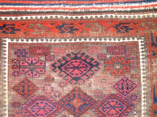 Khorosan Baluch rug, with corroded brown ground and design elements often associated with Timuri type weavings. Very intriguing central element. Lots of cochineal and madder.        