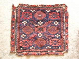 Baluch minakhani bagface ( khorjin fragment ) with saturated color and interesting features for the structurally inclined including alternating bands of Turkish and Persian knots and a pronounced pattern of weft shifts  ...