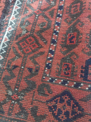 Small cinnamon ground Baluch rug with a 'scorpion' boteh field.