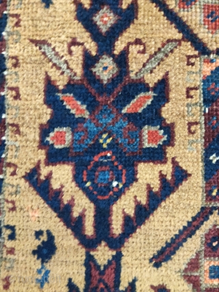 Small camel ground Baluch rug with stylized pallettes. Very fancy with highlights in white cotton pile, yellow wool pile (not camel), and peach. 2'6x3'2" Worn but very readable and enjoyable with great  ...