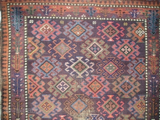 small symmetrically knotted Baluch rug with fantastic color (including three greens, several blues, pink, orange, purple and chocolate brown) and a simple border with geometricized flowering plants. 84x132 cm(33\'\'x52\'\' inches)   
