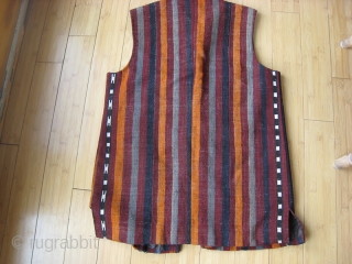 Man's vest tailored in Peshawar Pakistan of Kilim.  42 + inches across chest, 31 inches long.  Lined with khaki cotton.  woven leather buttons.       
