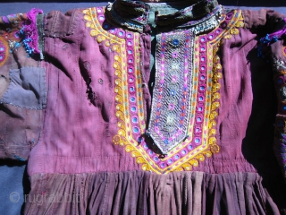 Antique Pushtoon tribal dress.  Red/brown cotton with heavy embroidery on sleeves and neck opening.  Multiple patches and some holes.  It was heavily worn before being purchased in Peshawar in  ...