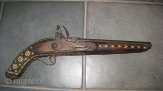 Antique decorated pistol from Tribal area of Pakistan. 18 inches long.  Wood and metal inlaid with bone.  Brass plate on barrel. Purchased in 1960's in NWFP, Pakistan.    