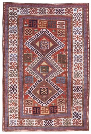 Karachopf Kazak, late 19th century. 74" x 51". a cheerful Kazak featuring a well-drawn ram's horn ivory border framing a red ground with an ivory outlined triple medallion. The ram's horn motif  ...