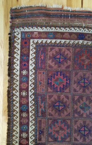 Baluch Rug. Unusual and very nicely balanced palette, with multiple shades each of blue, red and purple. 54" x 28". The design and the color would indicate an Aimaq origin. Evenly worn  ...