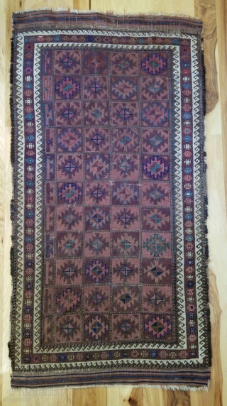 Baluch Rug. Unusual and very nicely balanced palette, with multiple shades each of blue, red and purple. 54" x 28". The design and the color would indicate an Aimaq origin. Evenly worn  ...