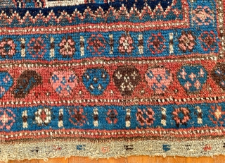 A very old Kurdish carpet, used too long on the floor, but potentially restorable. 76 inches x 52 inches (at widest), or 193 cm x 132 cm.  Pile ranging from good  ...