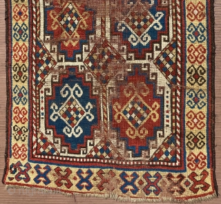 A 19th C. Memling-gul Kazak long rug. 41” x 97” (104 cm x 246 cm) Interesting yellow-ground border with archaic double rams-horn design.  Substantial areas without pile in the center, but  ...