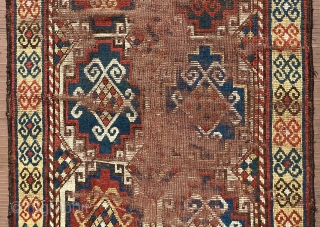 A 19th C. Memling-gul Kazak long rug. 41” x 97” (104 cm x 246 cm) Interesting yellow-ground border with archaic double rams-horn design.  Substantial areas without pile in the center, but  ...