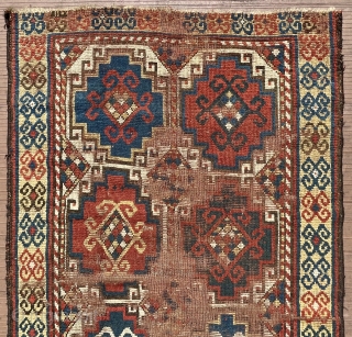 A 19th C. Memling-gul Kazak long rug. 41” x 97” (104 cm x 246 cm) Interesting yellow-ground border with archaic double rams-horn design.  Substantial areas without pile in the center, but  ...