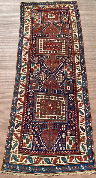 Eastern or southeastern Caucasus.  118” x 43” (301 cm x 1090 cm).  Older runner (mid 19th ?), with unusual design of large 3-lobed medallions.  Lots of other filler elements,  ...