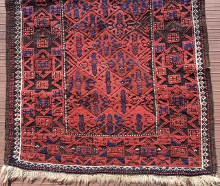 Baluch rug.  53” x 28” (135 cm x 72 cm)(Width varies). Very attractive little rug in good condition.  The surface appears embossed because the black is corrosive and worn shorter,  ...