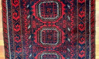  A attractive Baluch rug in excellent condition.   Size is typical for Baluch--67 inches x 35 inches (170 cm x 89 cm).  Turkmen design motifs—field with five Salor-like guls,  ...