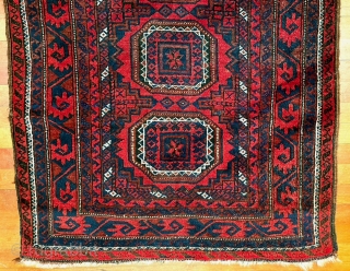  A attractive Baluch rug in excellent condition.   Size is typical for Baluch--67 inches x 35 inches (170 cm x 89 cm).  Turkmen design motifs—field with five Salor-like guls,  ...