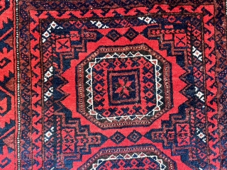  A attractive Baluch rug in excellent condition.   Size is typical for Baluch--67 inches x 35 inches (170 cm x 89 cm).  Turkmen design motifs—field with five Salor-like guls,  ...