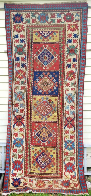 Kazak - about 8.9 x 3.7, Beautiful saturated color, wear areas throughout, newer side cords, overall repiling (mostly of ivory and yellow) and other scattered repairs/reweaves.       