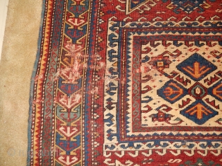 KAZAK OR KUBA RUG WITH BLUE SIDES , THIN RED WEFTS , AND BRAIDED ENDS ...DATED 1898
A BIT OF WEAR- 40 X 60 INCHES         