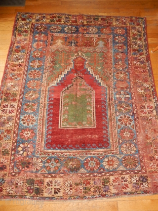 175 YEAR OLD ANTOLIAN PRAYER RUG WITH DECENT PILE AND SOME CRUDE REPAIRS HERE AND THERE. BEST GREEN AND RED DYES USED WITH A GOOD STRONG GOLD AND EARLY PURPLE
ALL NATURAL DYES  ...