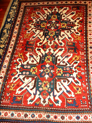 EAGLE KAZAK IN VERY GOOD PILEAND CONDITION 58 X 86 INCHES
NOTE THE NUMEROUS ANIMALS WANDERING IN THE FIELD               