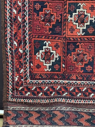 Baluch rug with overall design of Turkmen 'ayna' guls in full pile with complete plain-weave skirts - 2.44m x 1.17m (8' 0" x 3' 10").        