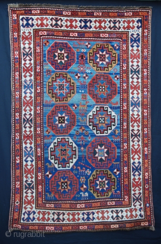 This stunning 19th century Moghan rug has a wonderful abrash of indigo-blue with the gols appearing to 'float' on the surface! The overall pile is evenly low but in good condition. 1.93m  ...