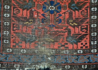 This rather battered but rare,interesting and very collectable Baluch 'cockerel' rug has knots which are symmetric indicating a possible 'Bahluli' attribution.
1.45m x 0.84m (4' 9" x 2' 9").     