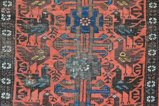 This rather battered but rare,interesting and very collectable Baluch 'cockerel' rug has knots which are symmetric indicating a possible 'Bahluli' attribution.
1.45m x 0.84m (4' 9" x 2' 9").     