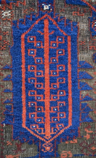 Early Baluch with heavily corroded brown-wool field but where the rest of the pile stands proud and gives a wonderful three-dimensional effect. No repairs whatsoever and complete with flat-woven skirts. Even with  ...