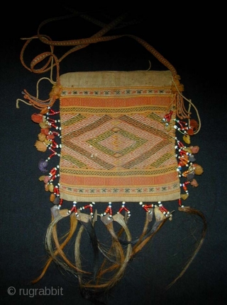 Timorese Betel-nut Bag (Aluk). Early 20th Century. Antoni people. Cotton flatweave and supplementary weft wrapping with glass beads, bamboo, and horsehair. 15 x 14 cms excluding strap and hair.    