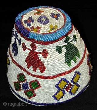 Beaded Hat. Kohistan. Mid-20th century or earlier. Great colours. Height 14, diameter 16 cms.                   