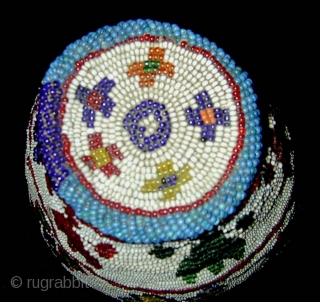 Beaded Hat. Kohistan. Mid-20th century or earlier. Great colours. Height 14, diameter 16 cms.                   