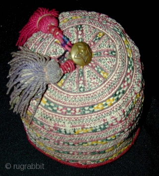 Turkmen Child's Embroidered Hat. Silk tassles and Soviet brass button. 1st half 20th c. Diameter 12, height 8 cms.              