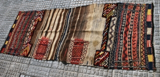 A very tribal Bakhtiari khorjin (double bag), prob. early 20th c. 90 x 240 cm. Unsewn sides. In good condition. Slight stains to one back. Very attractive pile parts and "fireplace" back  ...