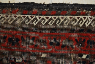 Antique Baluch with a rare plum ground and excellent palette, 2nd half 19th c. 91 x 160 cm. Uneven wear with loss to ends and deep black corrosion. Original sides. Some consolidating  ...