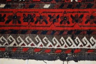 Antique Baluch with a rare plum ground and excellent palette, 2nd half 19th c. 91 x 160 cm. Uneven wear with loss to ends and deep black corrosion. Original sides. Some consolidating  ...
