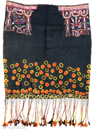 Cotton embroidery on "resist dying" felted wool textile. South Tunisian bride's headdress, first half 20th c. 83 x 91 cm (2'9" x 3')ex tassels. V good condition.      