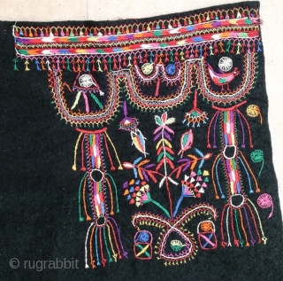 Cotton embroidery on "resist dying" felted wool textile. South Tunisian bride's headdress, first half 20th c. 83 x 91 cm (2'9" x 3')ex tassels. V good condition.      