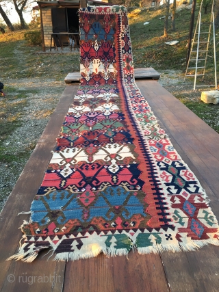 Antique Malatya kilim strip. Size is cm 75x395 or 2'8"x11'2" ca. Age is first quarter 19th century. Colors are simply wonderful: indigo, green, madder, cochineal, aubergine, etc....all fantastic. Some brown must have  ...