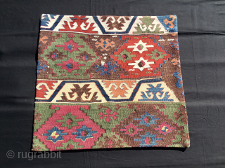 Simply a beautiful cushion......or Yastik in Turkish!
Anatolian kilim fragment mounted on black canvas with zipper.
Antique, natural saturated colors, lovely pattern with stars.
Size is cm 58x61. 
Approx date is end of the 19th  ...