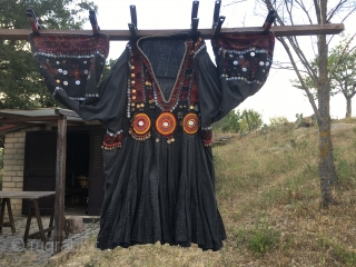 Nuristan. Jumlo or woman wedding dress from Kohistan/Nuristan, Northern Pakistan and Afghanistan. Heavily silk embroidered on black cotton, with lots of white and copper plastic buttons, metal roundels, lead beads, etc. Early  ...