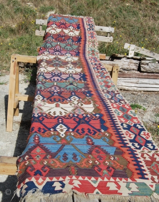 Antique Malatya kilim strip. Size is cm 75x395 or 2'8"x11'2" ca. Age is first quarter 19th century. Colors are simply wonderful: indigo, green, madder, cochineal, aubergine, etc....all fantastic. Some brown must have  ...