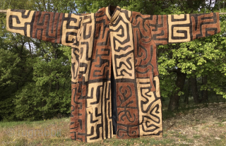 Bakuba raffia coat/jacket. 
Congo, probably early or mid 20th century. 
Unique, unisex coat for special people, exhibitions, tribal fashion venues. Terribly chic or kitsch, as you like.
The lady wearing the coat in  ...