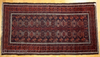 Baluch Timuri, a so called Sangtshuli; about 1880; 105 x 186cm (3`5”x 6`1”) rare seen main border (not found comparable border in Baluch rug books), like a row/chain of triangle amulets (an  ...
